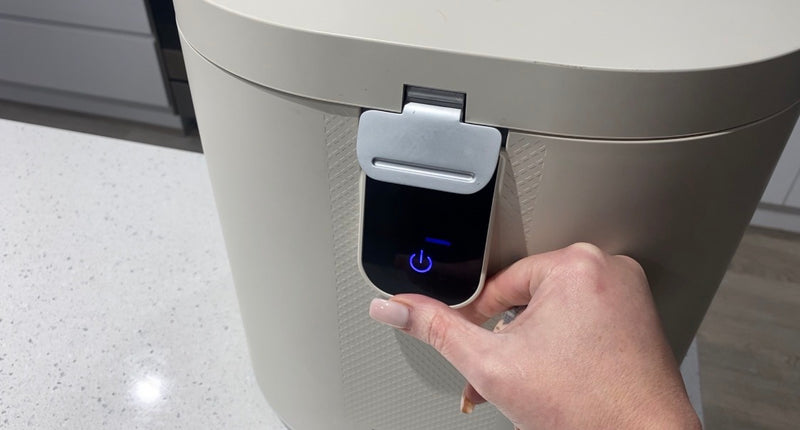 Pressing the one-touch start button on the Eco 5